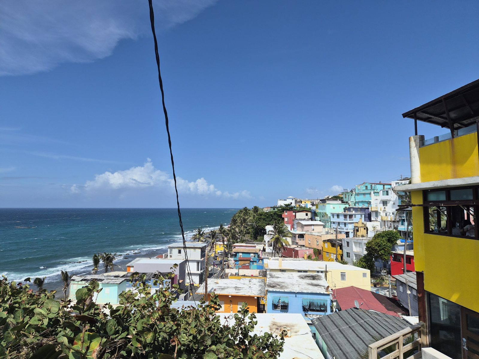 The colorful houses of La Perla running down the hillside to the Atlantic