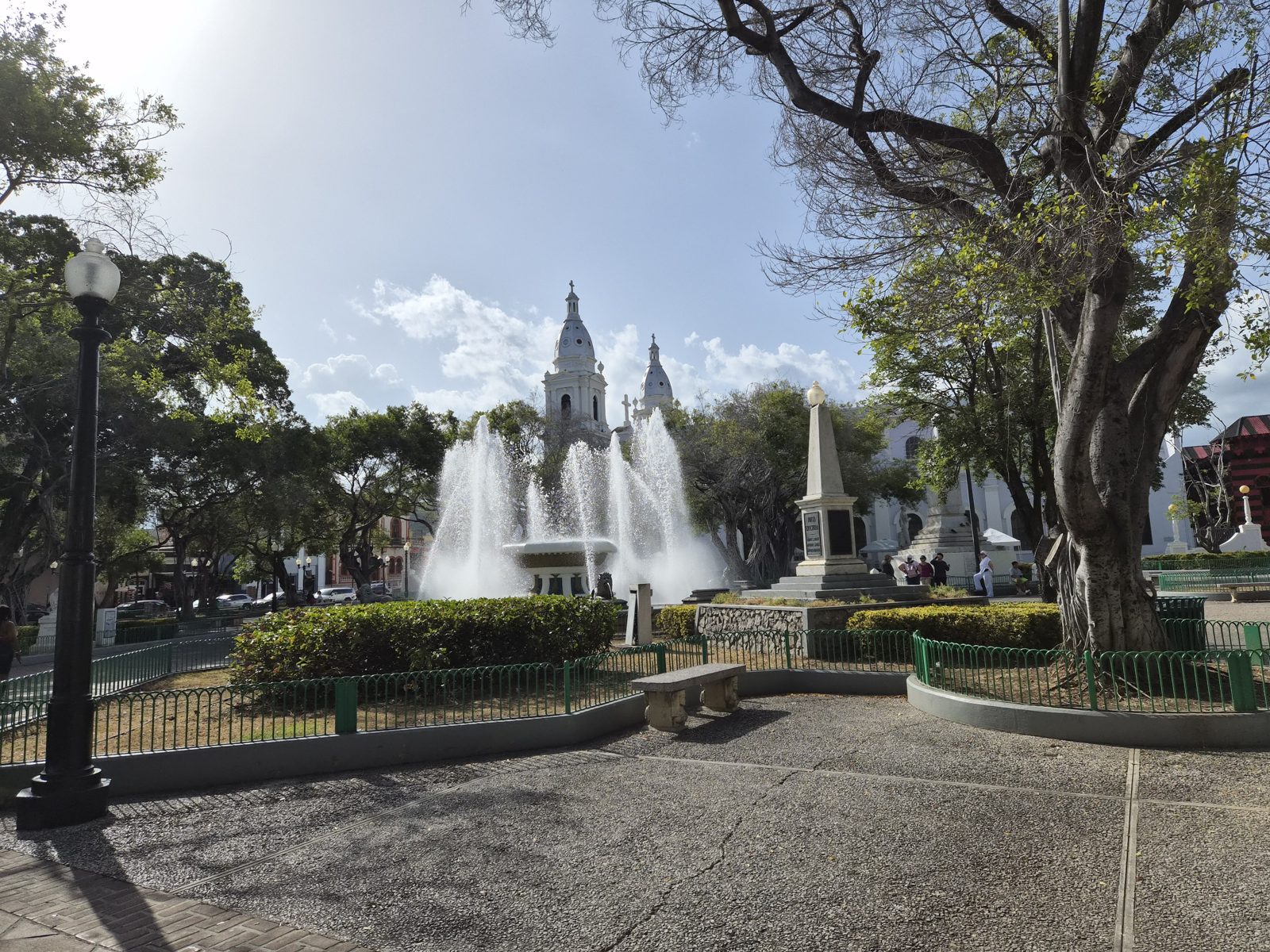 The plaza in Ponce with fountains and the cathedral behind the trees
